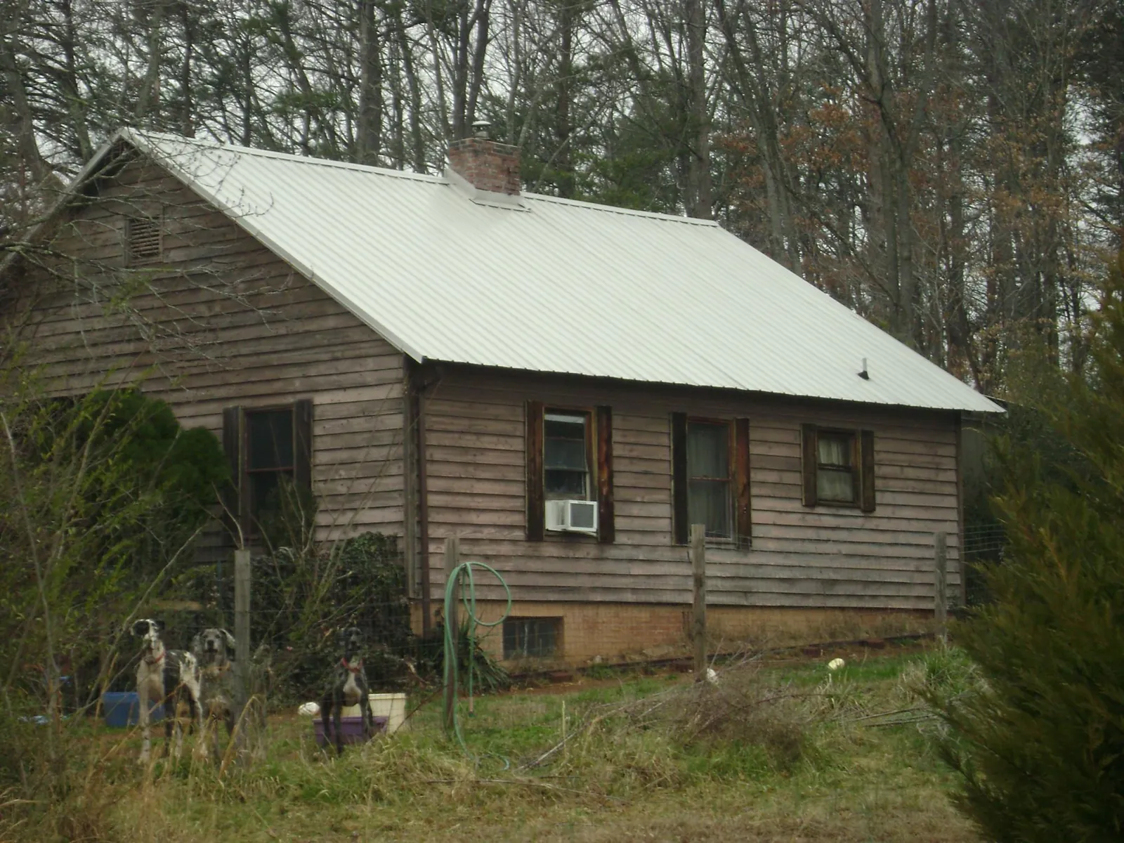 White metal roof on an old wood sided farmhouse, from a Metal Roof Installation job in Bretz